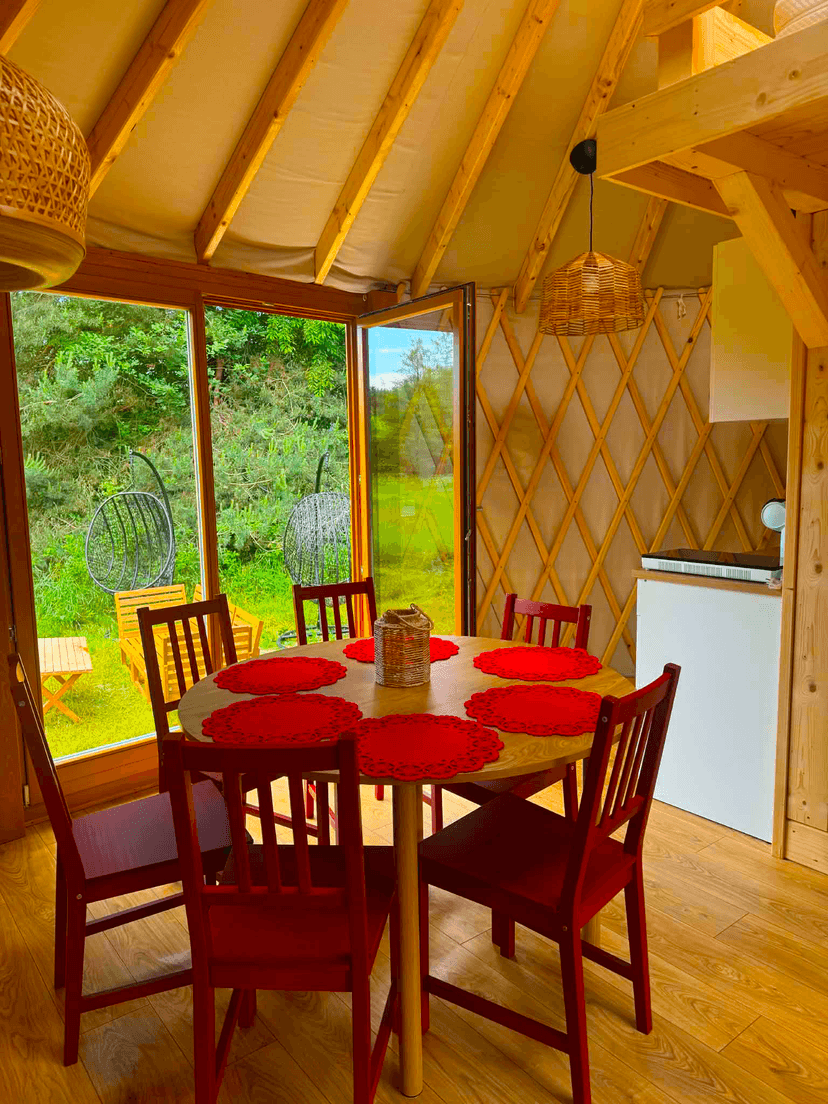 An open window with a view of a table and chairs.